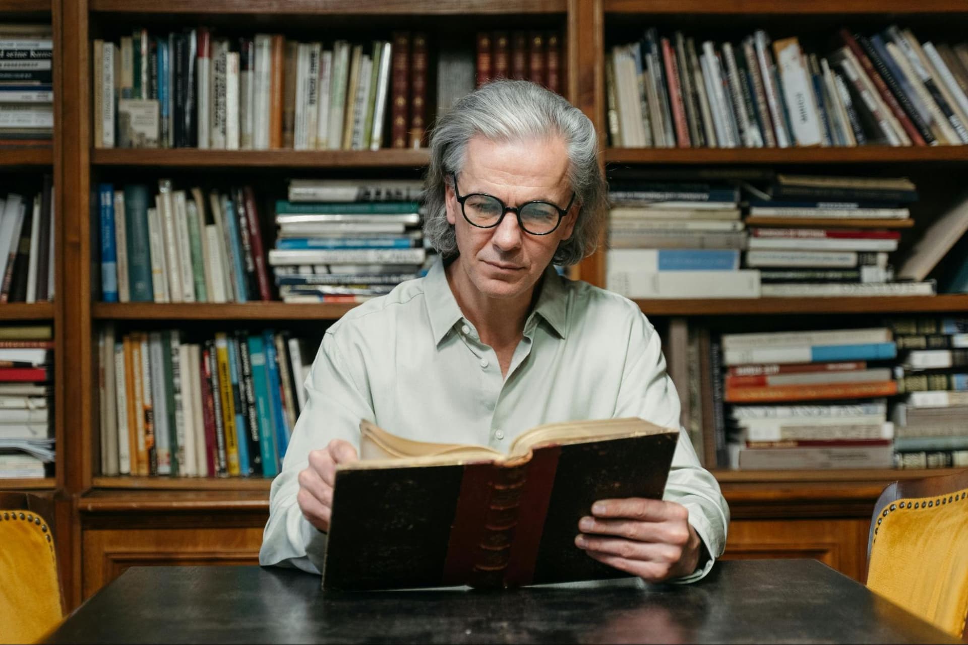 A man reading a book in a library