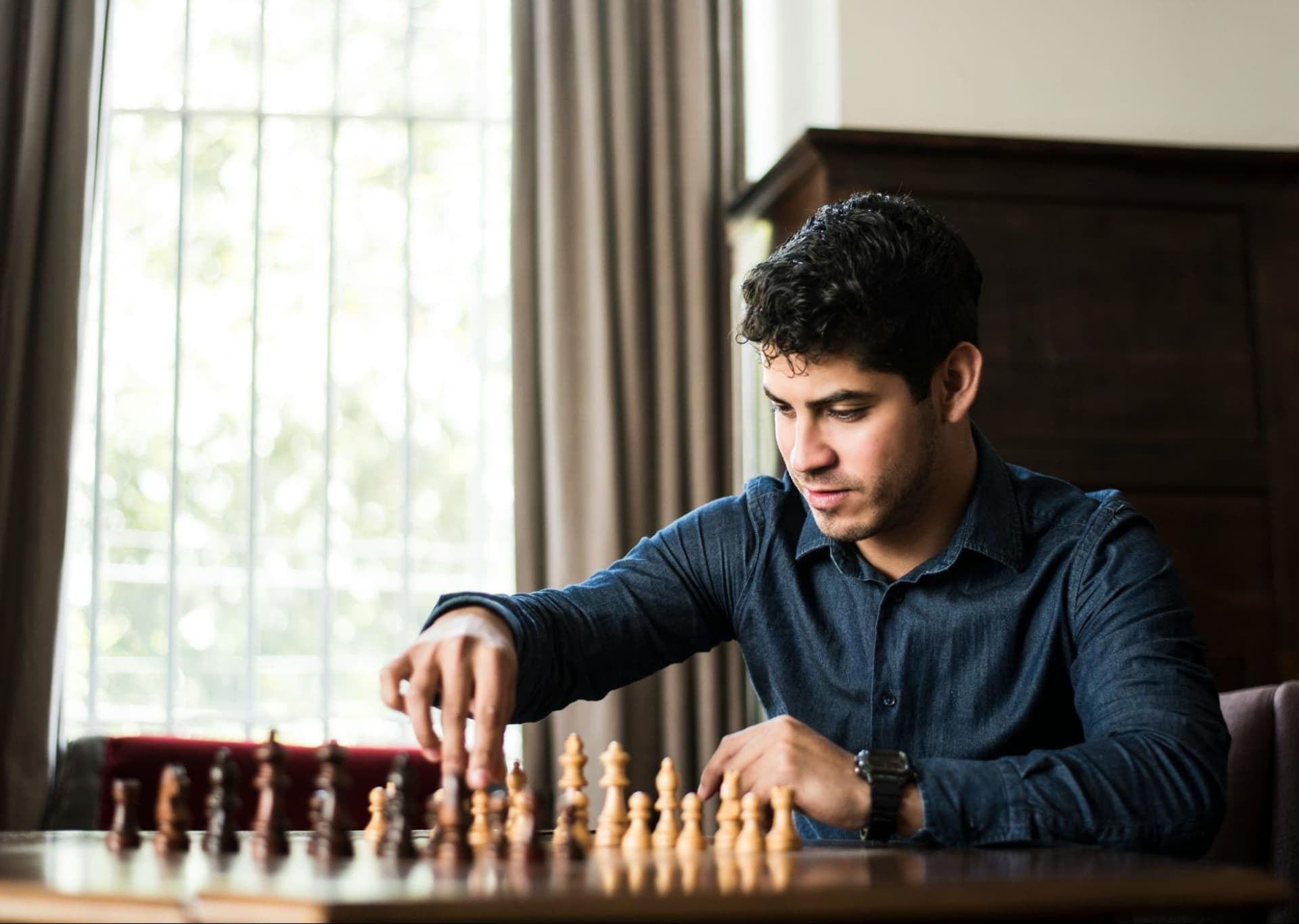 A man setting up a chess board
