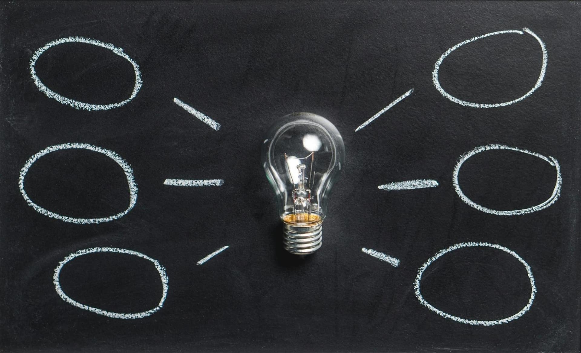 Graphic showing a lightbulb with drawn lines radiating outward to multiple circles, symbolizing ideas or connections