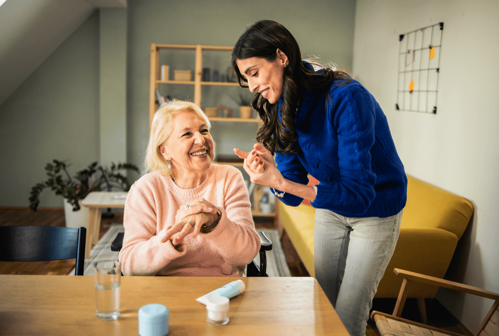 A caregiver or companion assisting an elderly woman