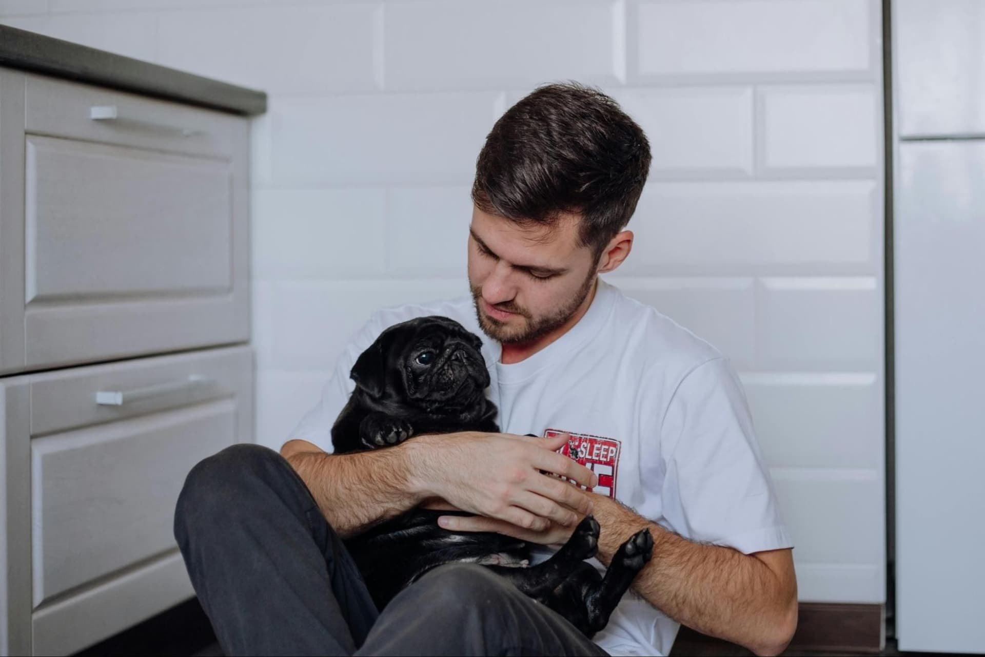 A man holding a puppy
