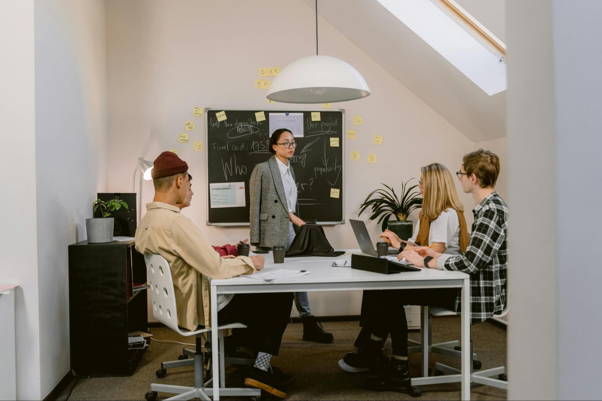 five people in a workplace meeting