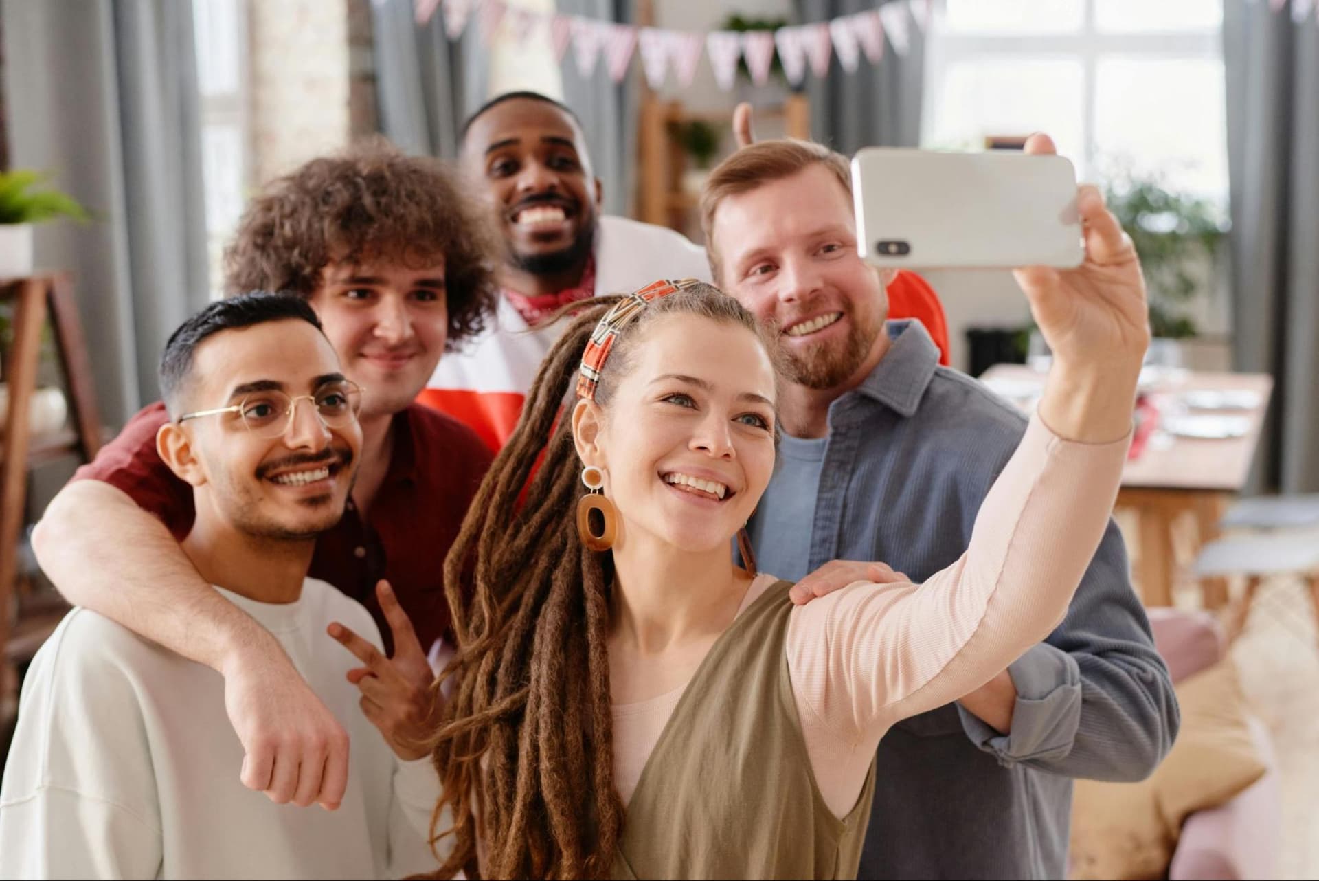 Five people taking a group selfie