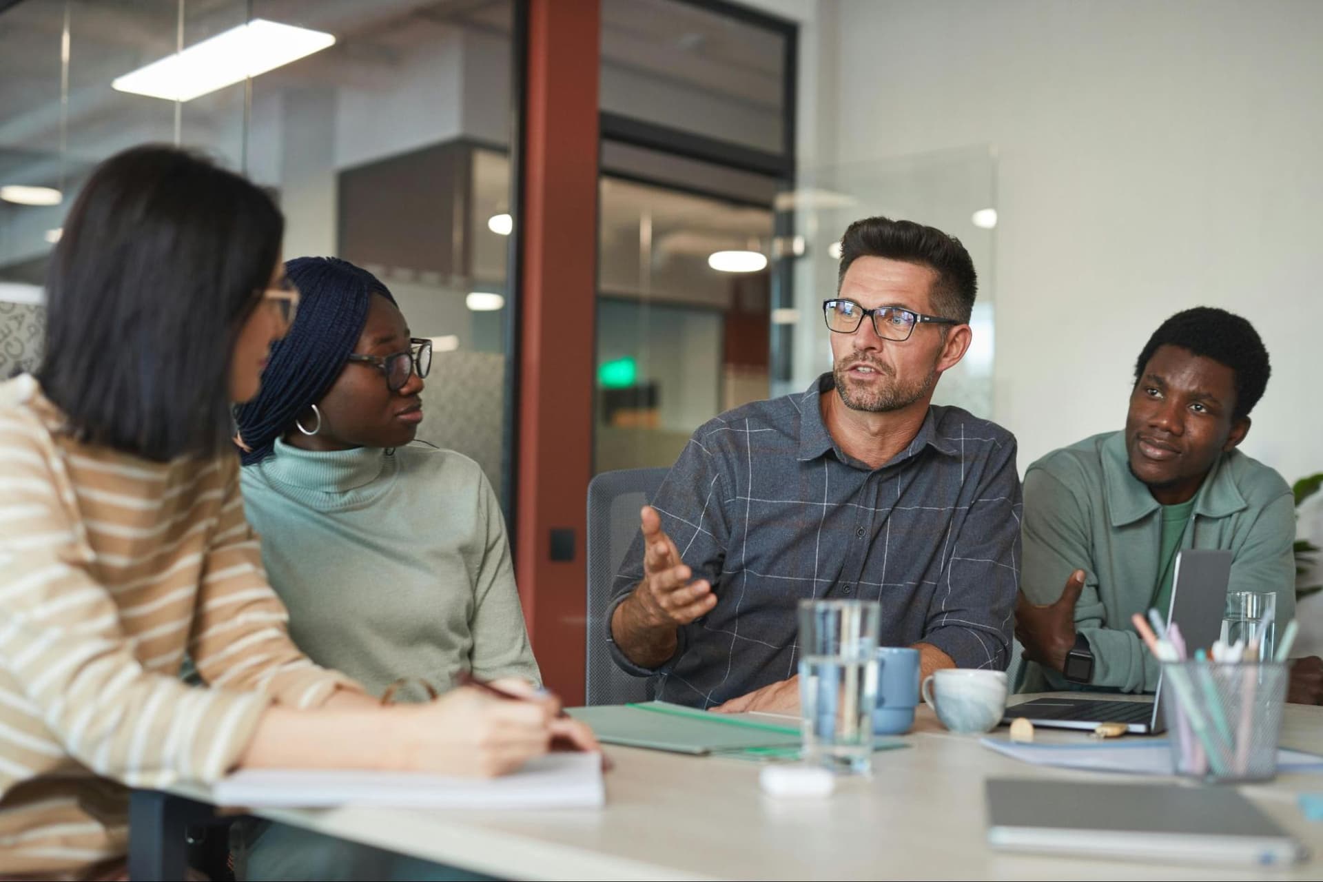 Four people in a corporate meeting