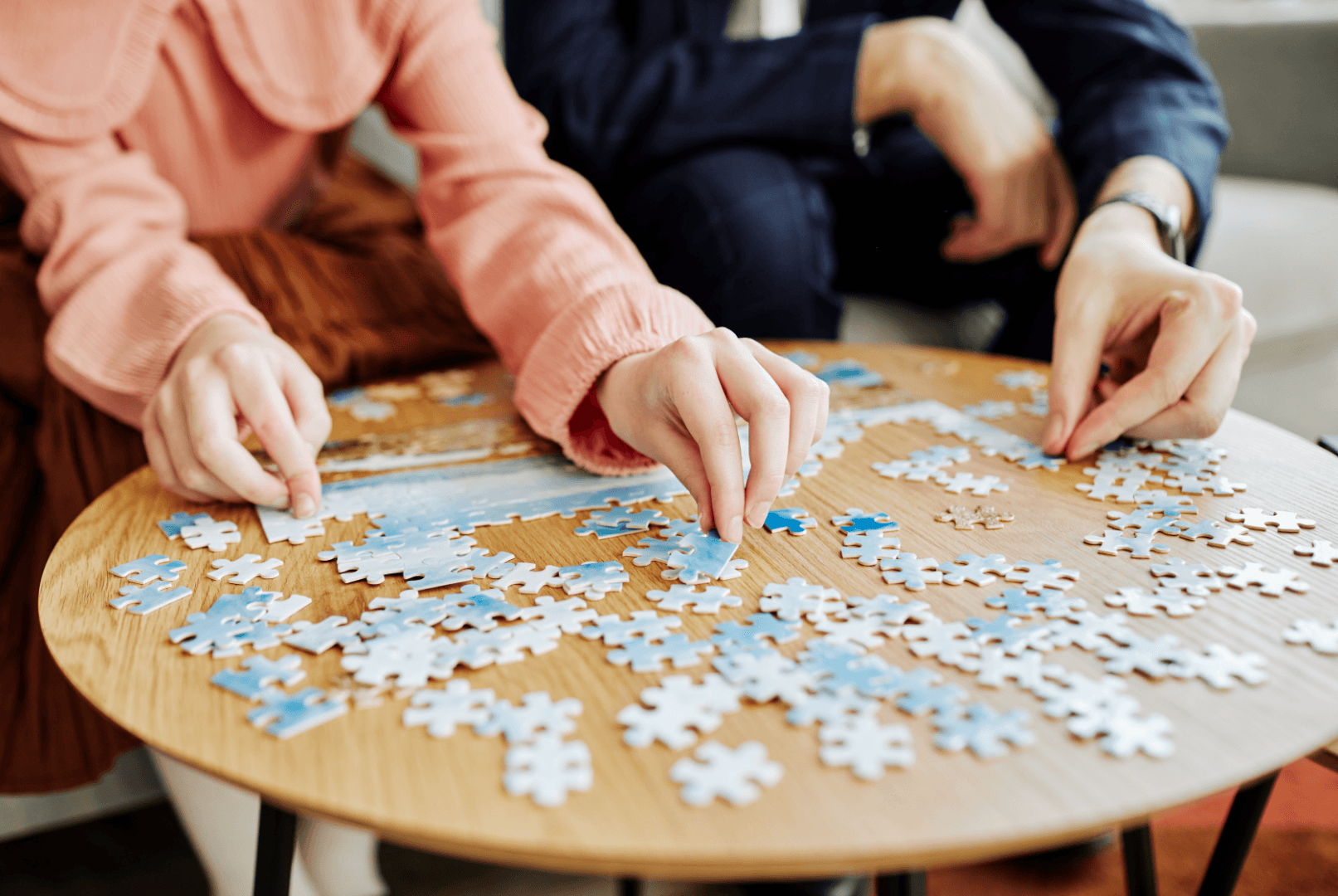 Two people solving a jigsaw puzzle