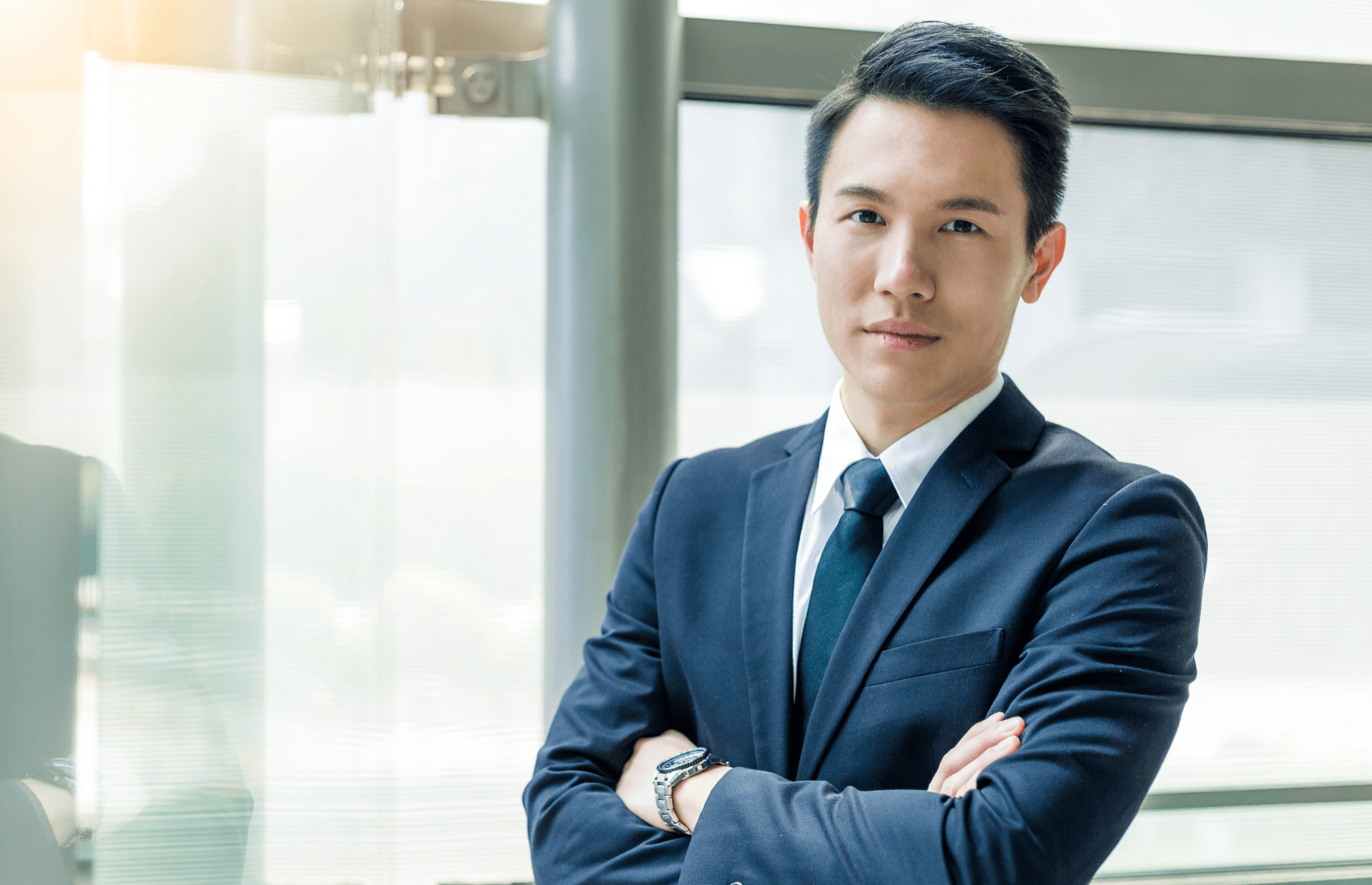 A businessman in a suit looking at the camera