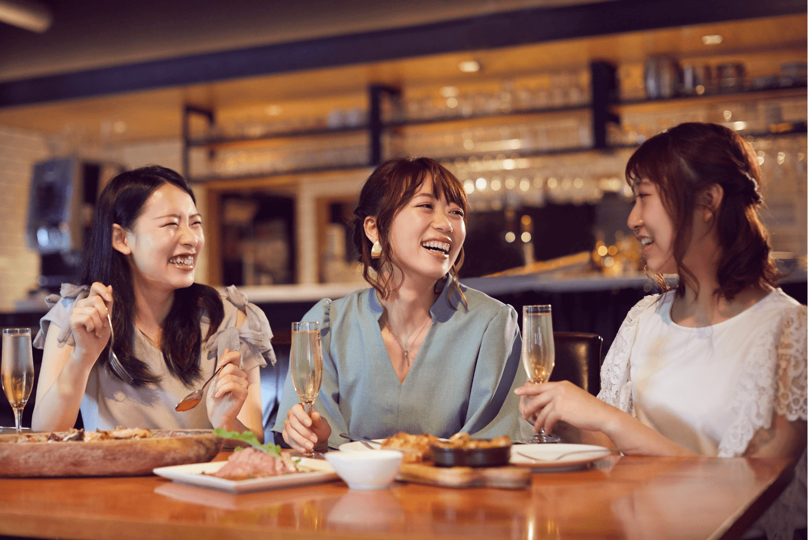 Three women eating at a restaurant and engaged in a friendly conversation