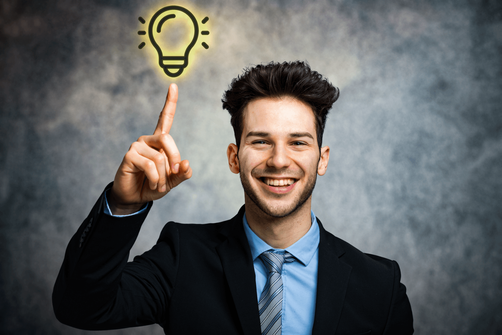 A cheerful young man points toward a glowing lightbulb above him, symbolizing an idea or innovation
