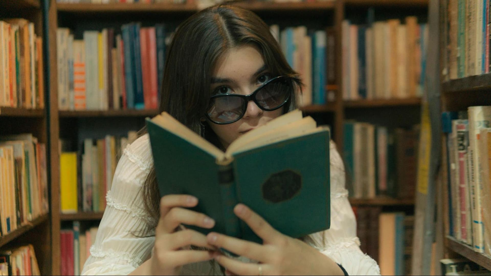 A girl reading a book in a library